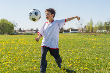Boys kicking football