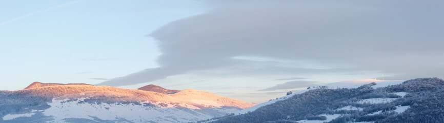 Sunrise Carpathian mountain winter panorama.