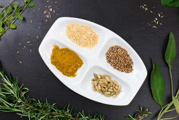 aromatic herbs and spices over slate sheet