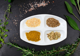 aromatic herbs and spices over slate sheet