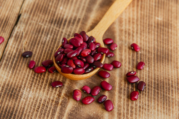 raw dried beans on a wooden surface