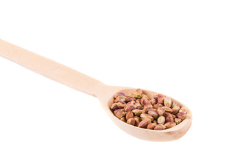 Wooden spoon with pistachios.