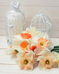 Background with fresh narcissus and candles