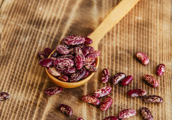 raw dried beans on a wooden surface