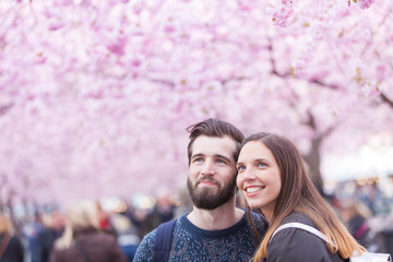 Hipster couple portrait in Stockholm with cherry blossoms