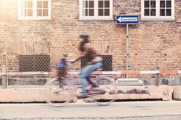 Obraz na płótnie Canvas Blurred person going by bike in Copenhagen
