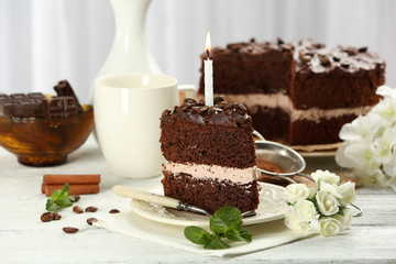 Delicious chocolate cake on table on light background