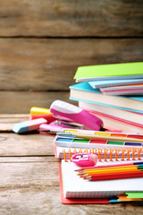 Bright school stationery on old wooden table