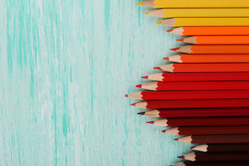 Colorful pencils on wooden table