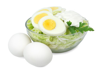 Bowl with a salad of cabbage boiled eggs.