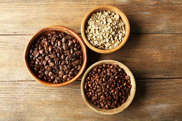 Coffee beans on wooden table, top view