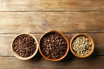 Coffee beans on wooden table, top view