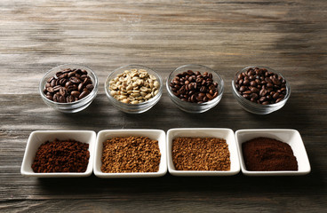 Coffee beans in saucers on wooden background