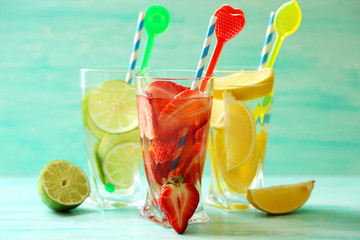 Cocktails with fresh strawberries and lemon lime on wooden background