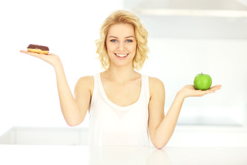 Happy woman with donut and apple