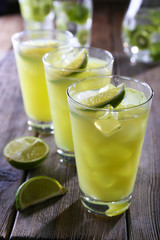 Glasses of cocktails on wooden table, closeup