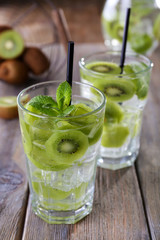 Glasses of cocktails on wooden table, closeup
