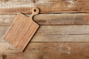 Cutting board on wooden background