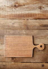 Cutting board on wooden background