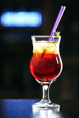 Glass of cocktails on bar background
