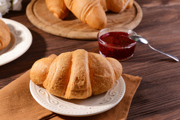Delicious croissants on plate on table close-up
