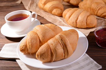 Delicious croissants on plate on table close-up