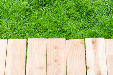 Fototapeta premium Wood on grass background