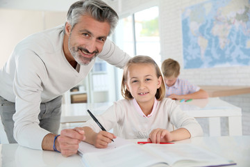 Teacher with schoolgirl in class
