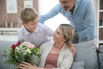 Young boy giving flowers to mommy for mother's day