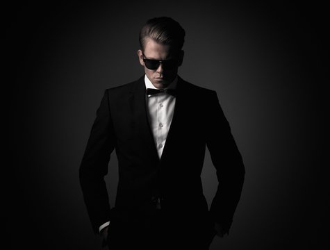 Confident sharp dressed man in black suit