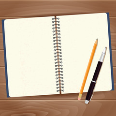 Clean note pad with pen and pencil on wooden background.