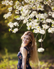 woman standing in blooming tree