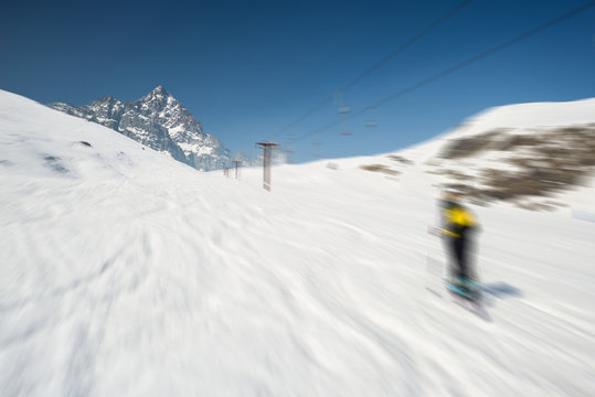 Blurred motion skiing in scenic alpine resort