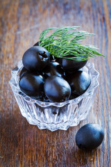Black olives on a wooden table