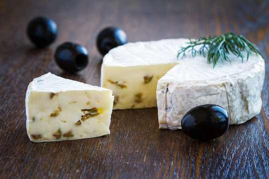 Piece of Brie Cream Cheese with olives