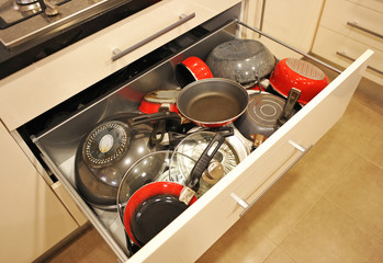 Kitchen drawer full of pans