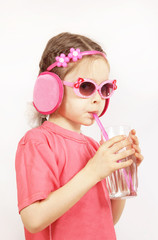 Little cute girl wearing pink clothes is drinking water