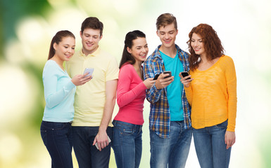 group of smiling teenagers with smartphones