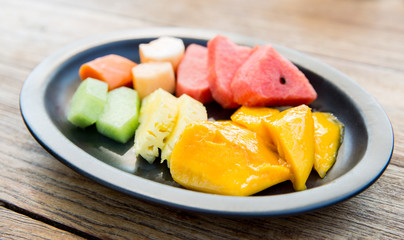 plate of fresh juicy fruits at asian restaurant