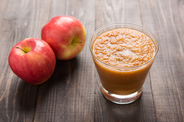 Flash red apples smoothie on Wooden background