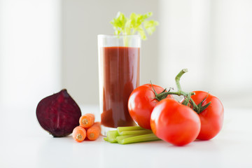 close up of fresh juice and vegetables on table