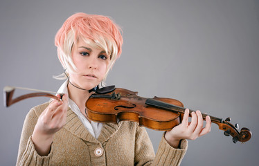 Young performer woman playing the violin