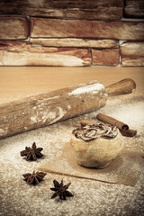 Homemade pastries on a light wooden table with flour. Toned