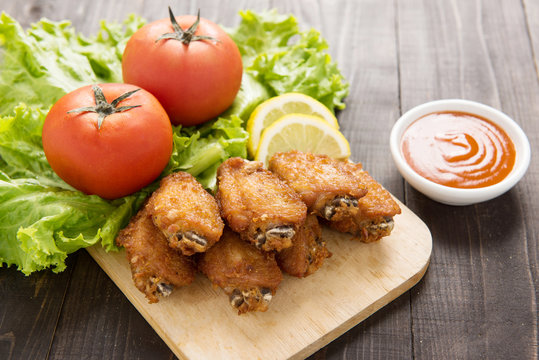 Fried chicken wings on wooden background