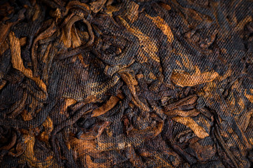famous pressed ripe Puer tea in Chinese cake closeup