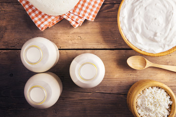 Variety of dairy products laid on a wooden table background