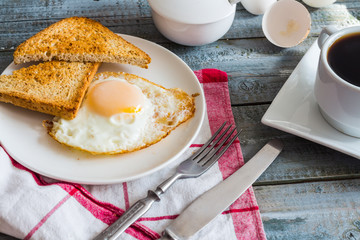 crispy toast with a fried egg and a cup of coffee. breakfast