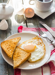 crispy toast with a fried egg and a cup of coffee. breakfast