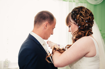 Young wedding couple indoors portrait.