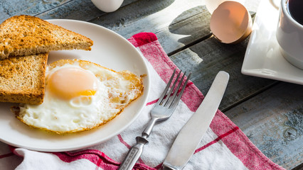 crispy toast with a fried egg and a cup of coffee. breakfast